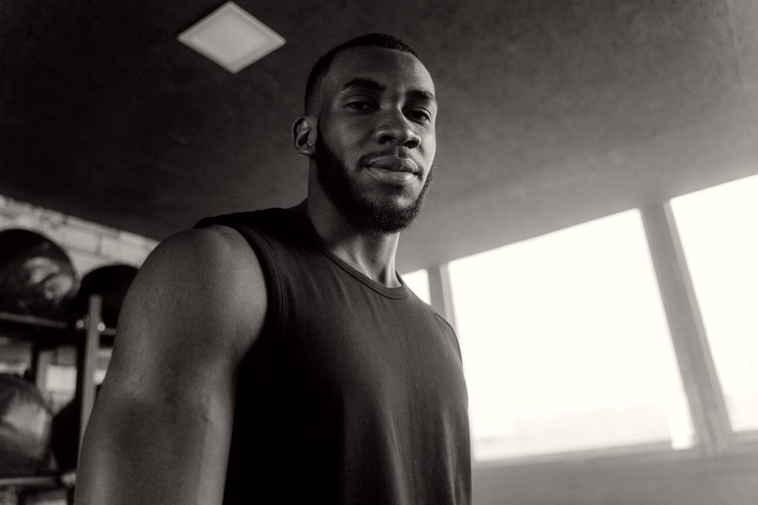 Man training in a sunlit gym