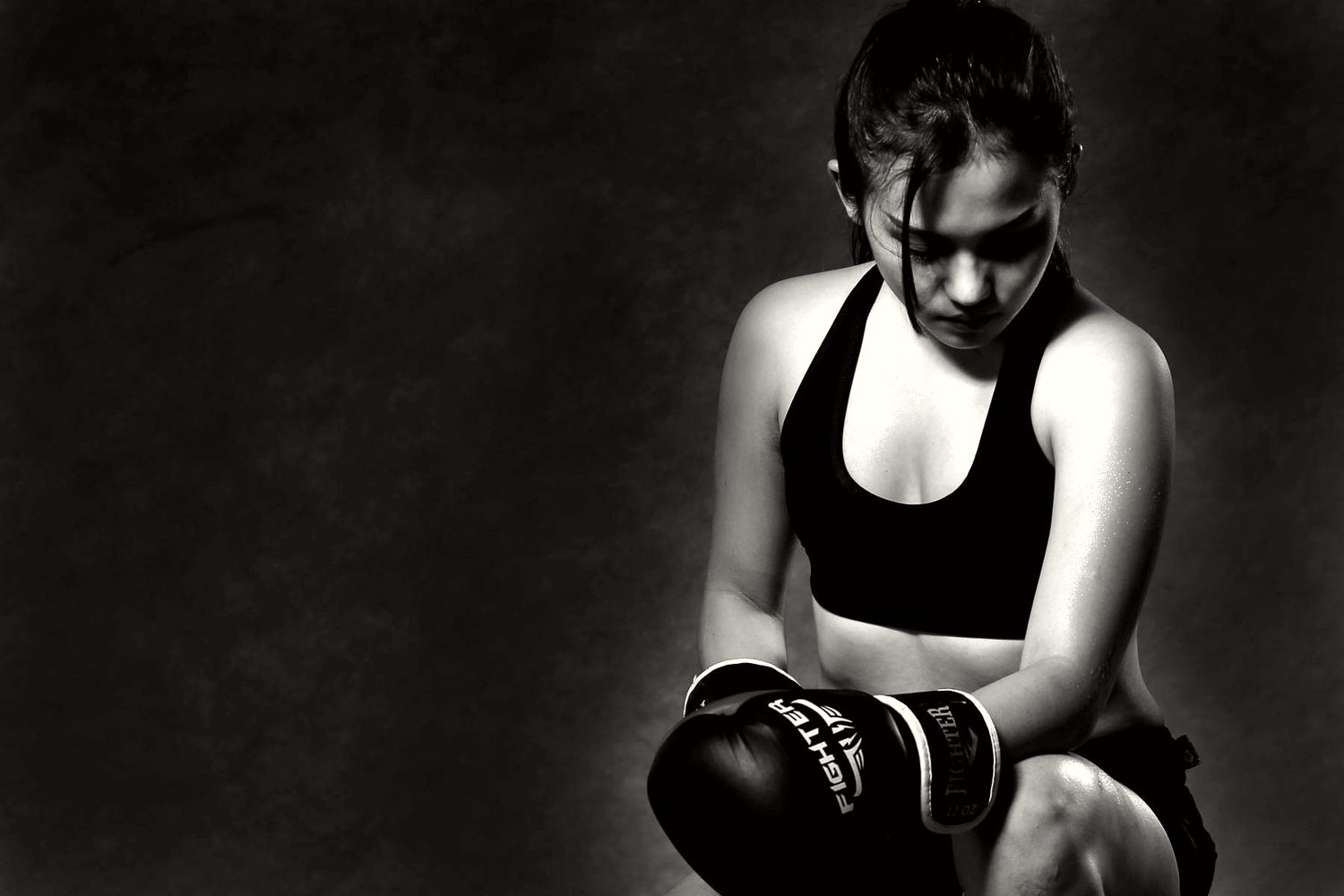 Woman resting between boxing rounds